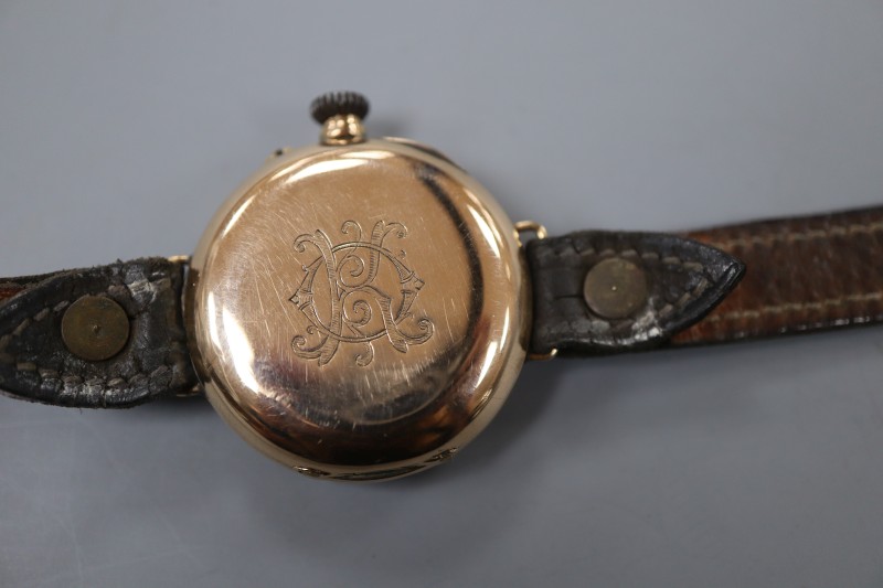 A ladys early 20th century 585 yellow metal manual wind wrist watch, on a leather strap.
